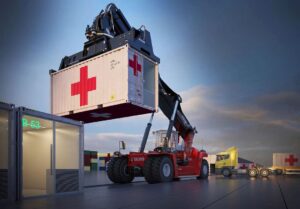 Crane lifting portable hospital container.